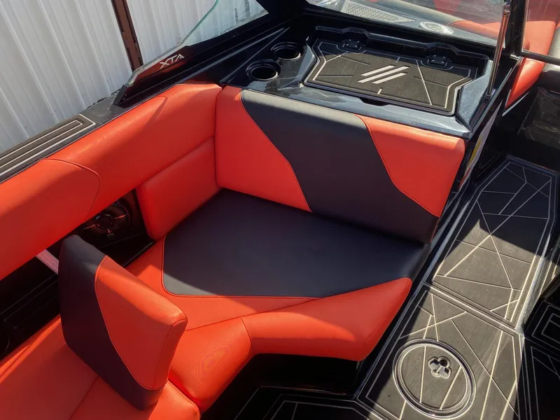 Slide: The Image of 2021 ATX Surf Boats 22 Type-S interior with red and black seating and geometric flooring. - 9