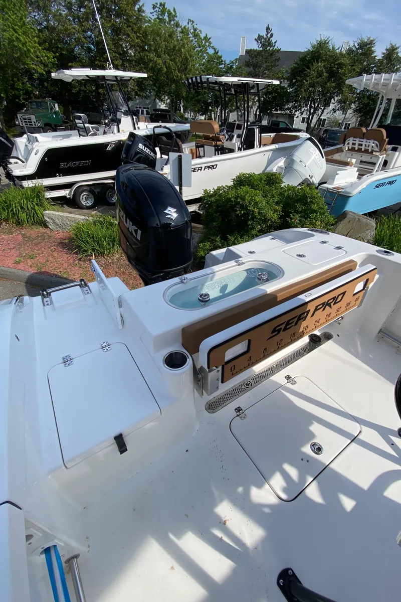 Slide: The Image of 2025 Sea Pro 222 Center Console boat with Suzuki outboard motor, docked outdoors. - 6