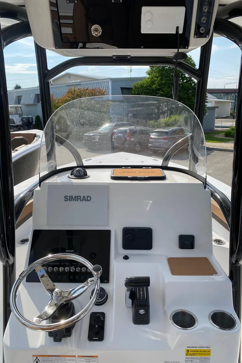 Slide: The Image of 2025 Sea Pro 222 Center Console boat dashboard with steering wheel and Simrad navigation system. - 7