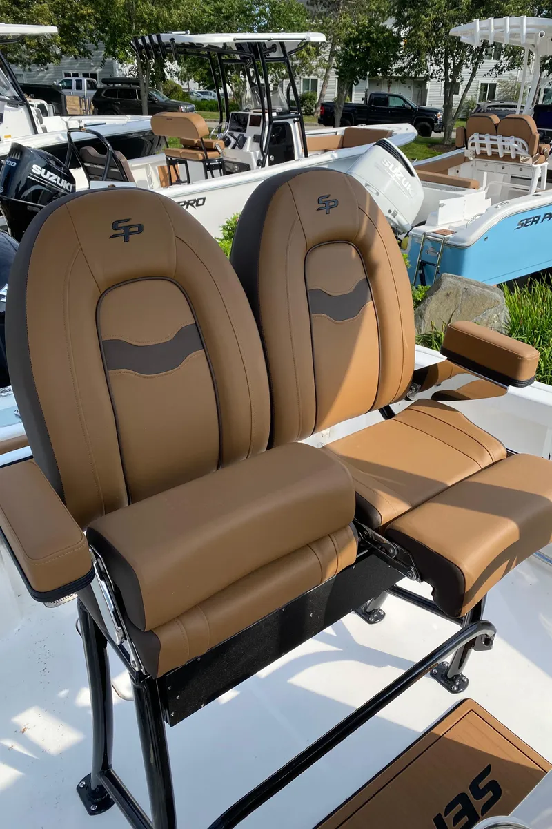 Slide: The Image of 2025 Sea Pro 222 Center Console boat with brown cushioned seats and sleek design. - 8