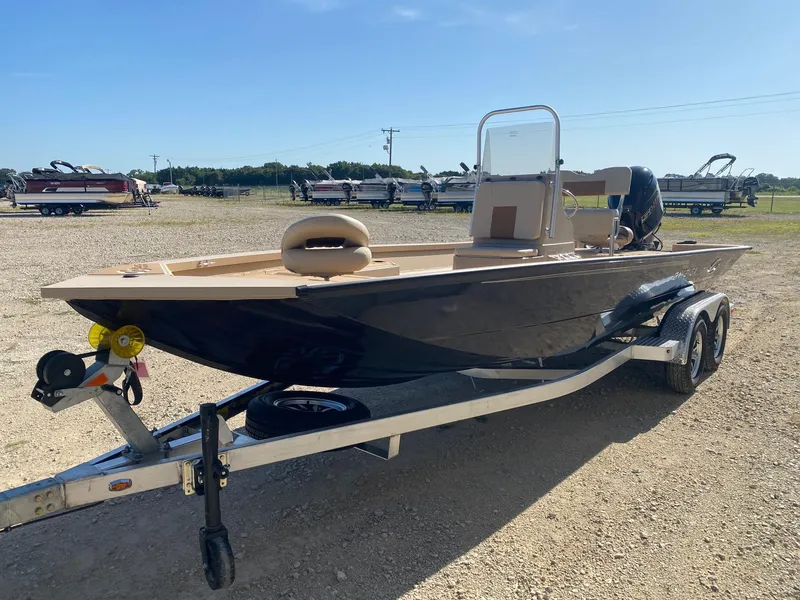 Slide: The Image of 2025 G3 Bay 21 GX boat on trailer in outdoor setting, ready for transport. - 2