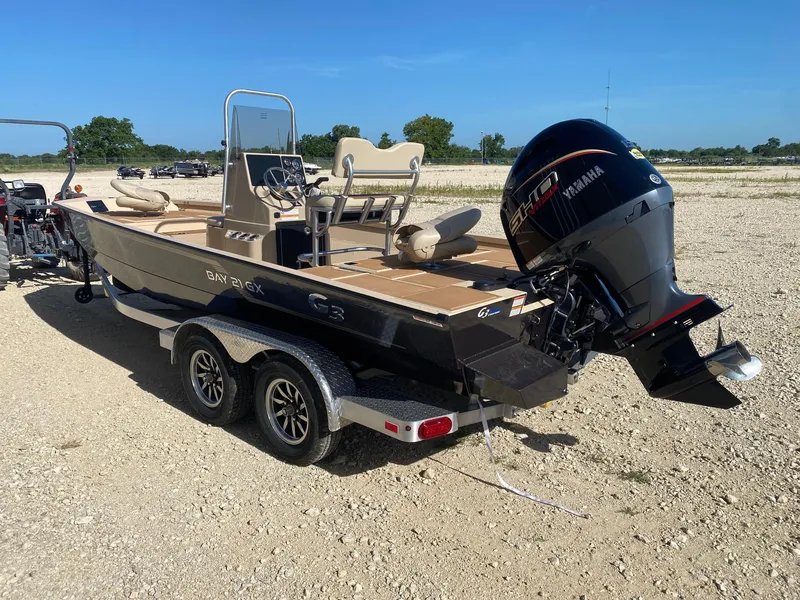 Slide: The Image of 2025 G3 Bay 21 GX boat with Yamaha engine on a trailer, parked outdoors. - 3
