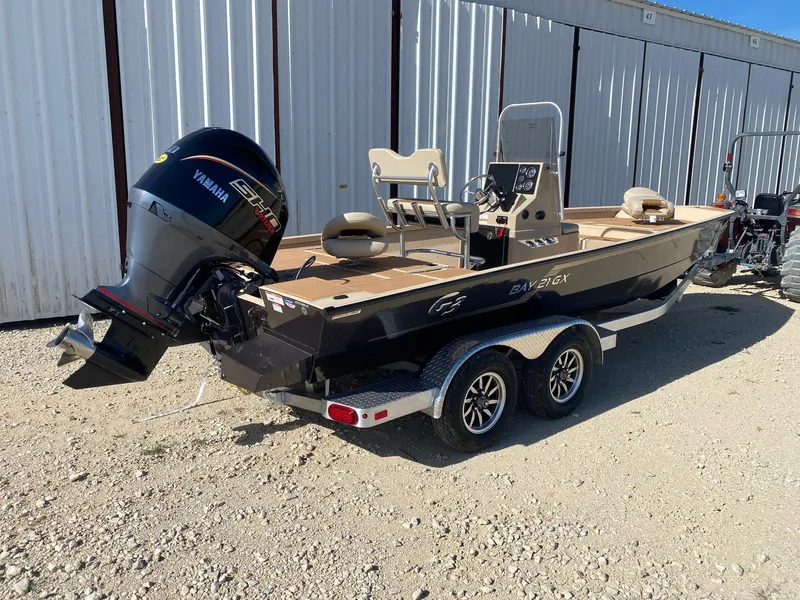 Slide: The Image of 2025 G3 Bay 21 GX boat with Yamaha engine on a trailer, parked outdoors. - 5