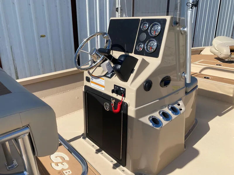 Slide: The Image of 2025 G3 Bay 21 GX boat console with steering wheel and gauges. - 6