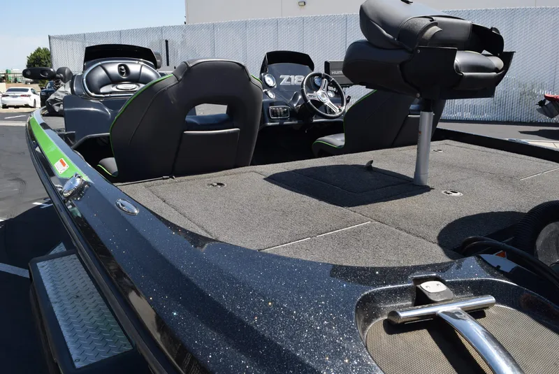 Slide: The Image of 2018 Nitro Z18 boat interior with seating and steering wheel, parked outdoors. - 5