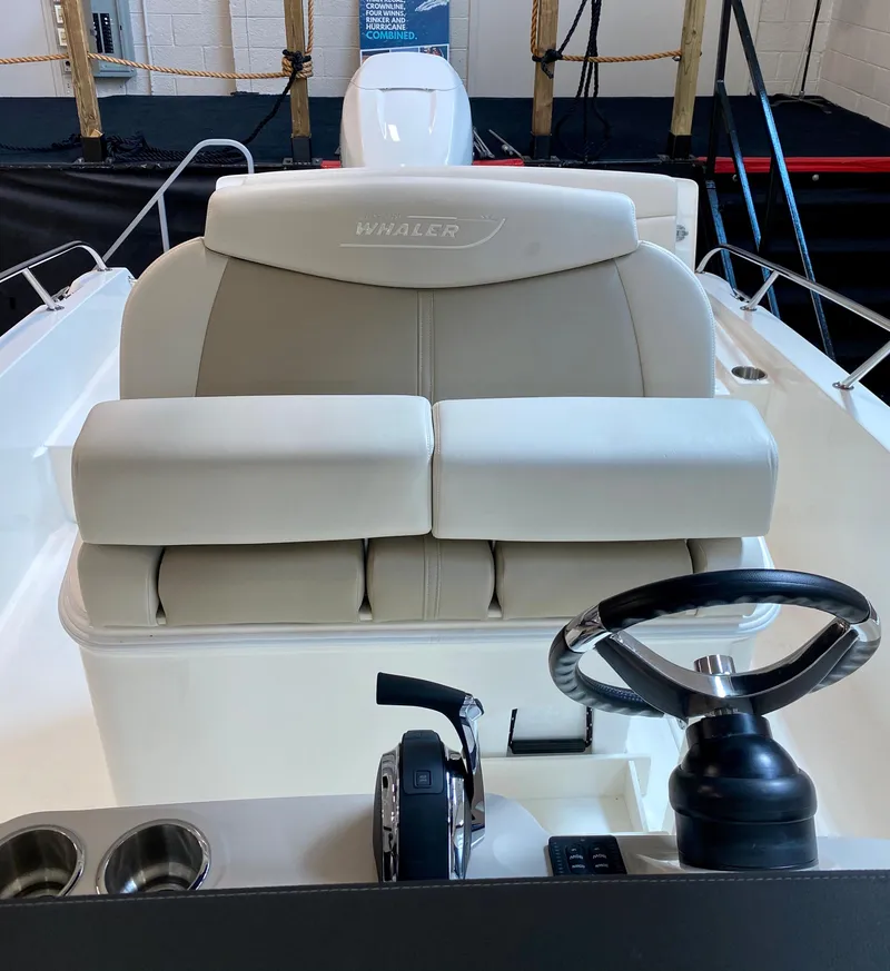 Slide: The Image of 2021 Boston Whaler 270 Dauntless boat interior with steering wheel and seating. - 3