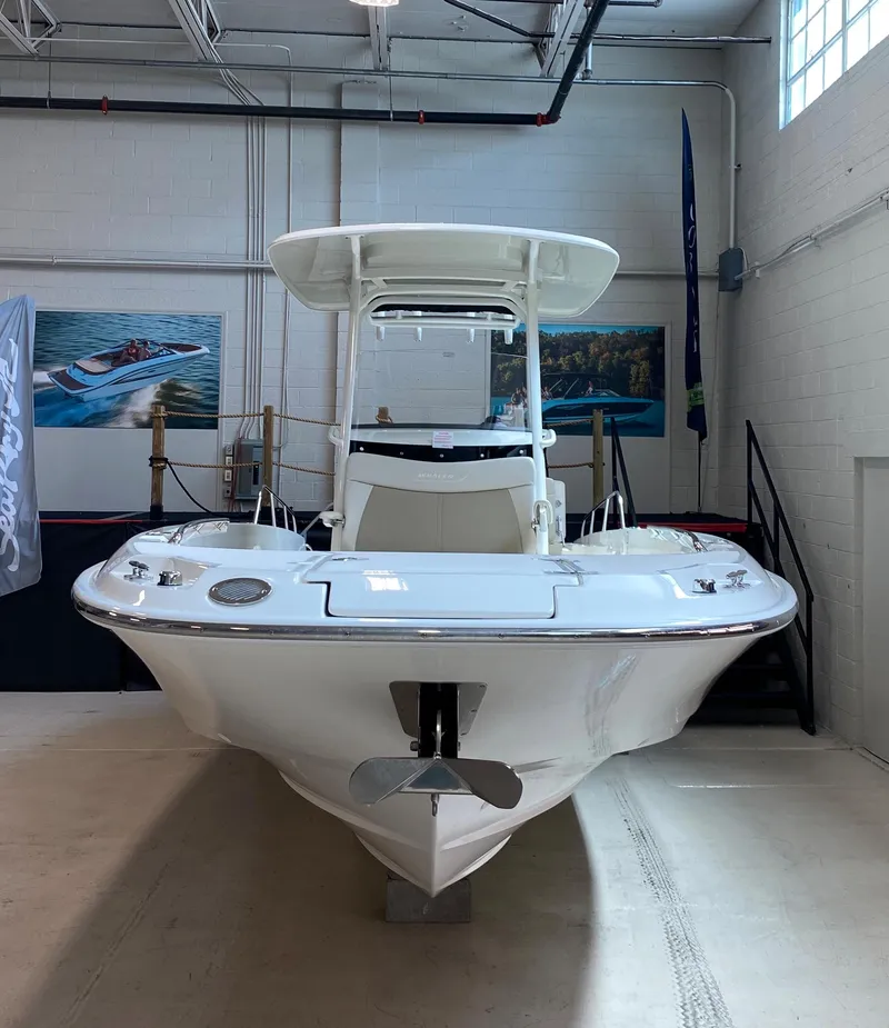 Slide: The Image of 2021 Boston Whaler 270 Dauntless boat displayed indoors, showcasing sleek design and modern features. - 7