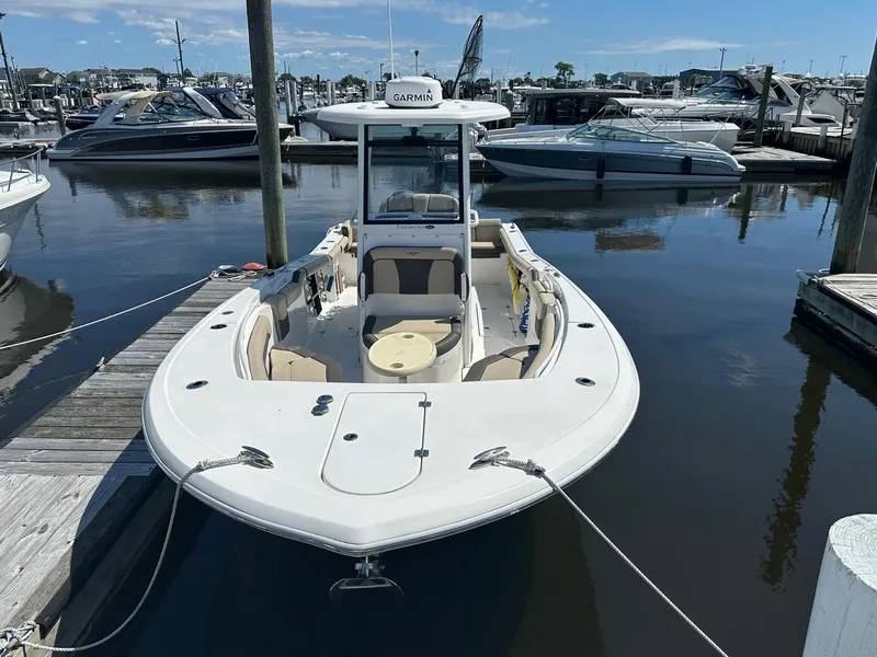 Slide: The Image of 2021 Tidewater 252 LXF boat docked at marina, featuring spacious seating and Garmin equipment. - 1