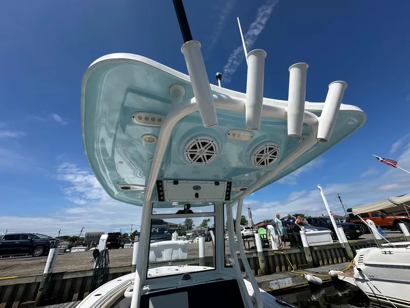 Slide: The Image of 2021 Tidewater 252 LXF boat with T-top and rod holders at a marina. - 11