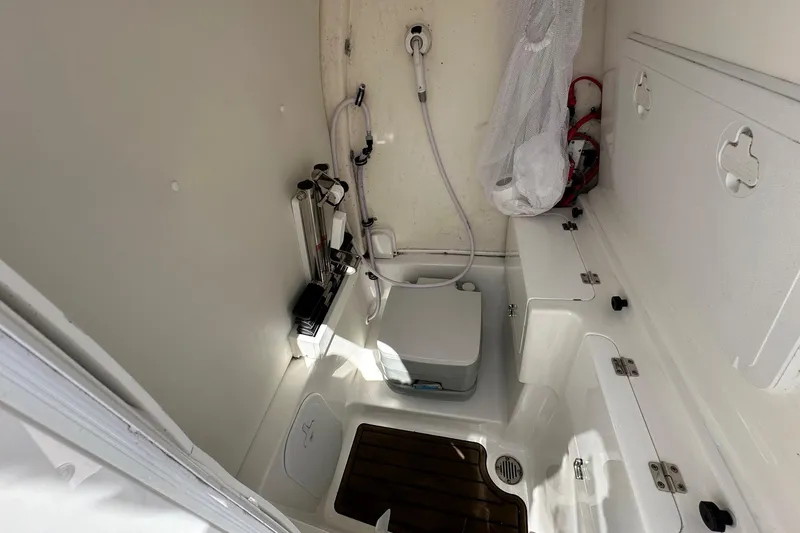 Slide: The Image of 2021 Tidewater 252 LXF boat interior with shower and storage compartments. - 12