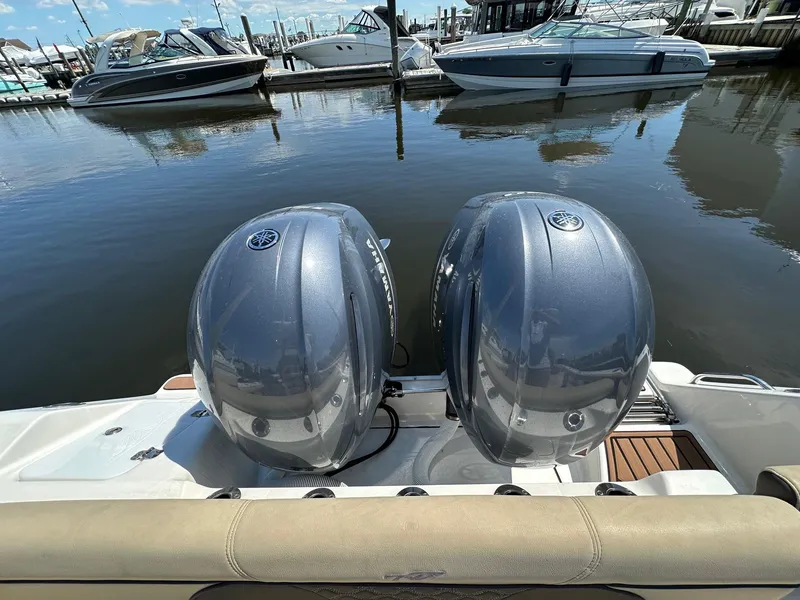 Slide: The Image of 2021 Tidewater 252 LXF boat with dual Yamaha outboard engines at marina. - 13