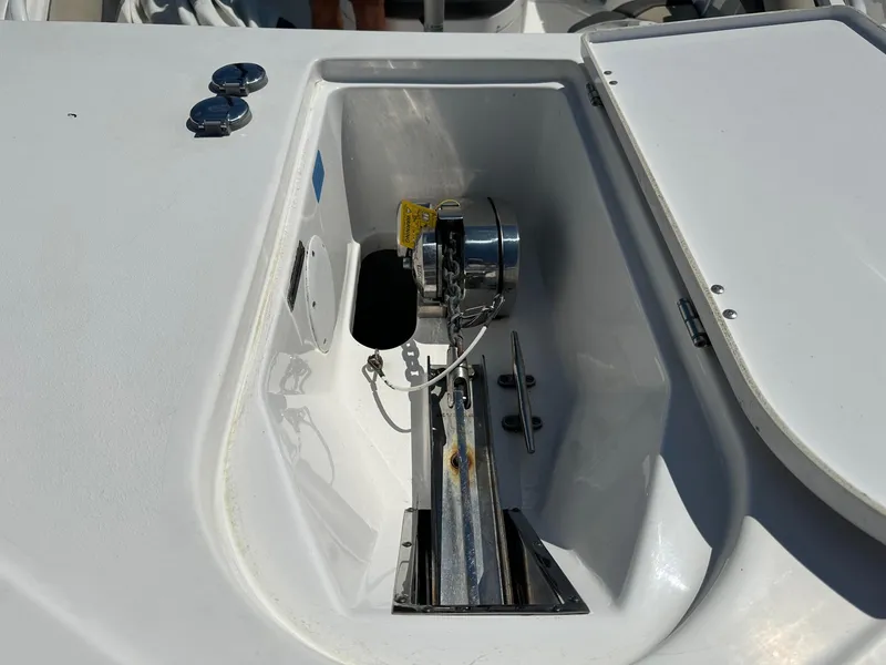 Slide: The Image of 2021 Tidewater 252 LXF boat anchor compartment with chain and winch system. - 15