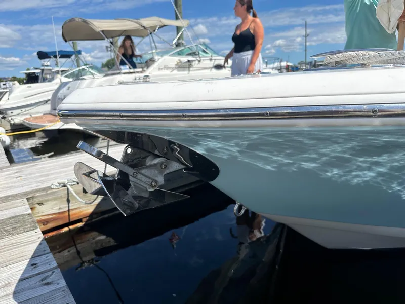 Slide: The Image of 2021 Tidewater 252 LXF boat docked, with people nearby under a sunny sky. - 16