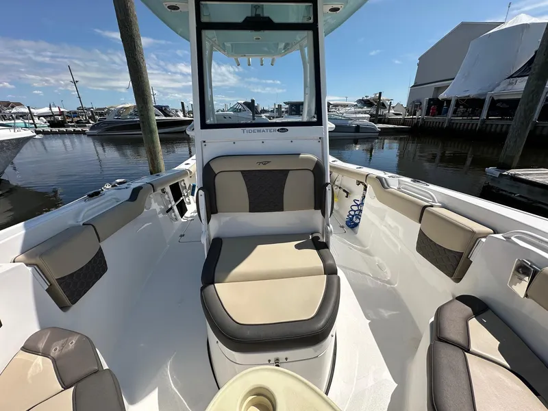 Slide: The Image of 2021 Tidewater 252 LXF boat interior with seating, docked at marina. - 3