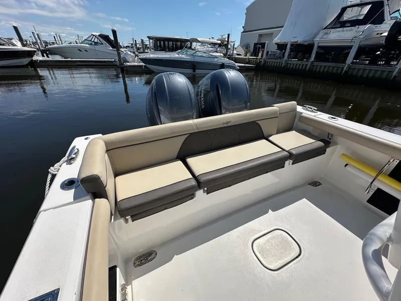 Slide: The Image of 2021 Tidewater 252 LXF boat with dual engines docked at marina. - 7