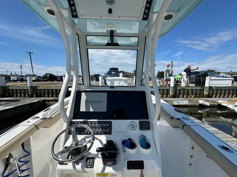 Slide: The Image of 2021 Tidewater 252 LXF boat dashboard with Garmin navigation at marina dock. - 8