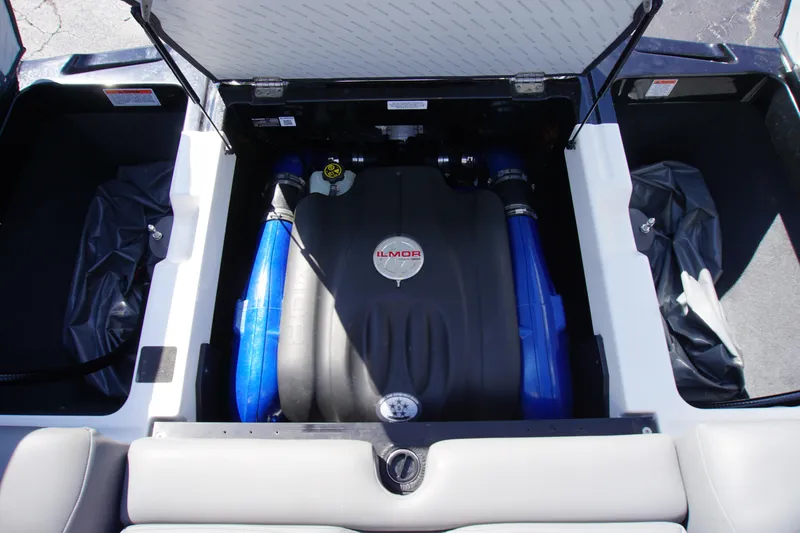 Slide: The Image of 2019 MasterCraft XT23 engine compartment with Ilmor engine and blue hoses. - 12