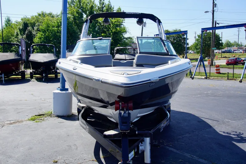 Slide: The Image of 2019 MasterCraft XT23 boat on trailer in outdoor dealership lot. - 4