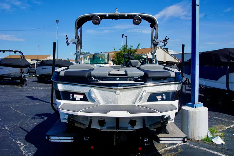 Slide: The Image of 2019 MasterCraft XT23 boat displayed in a marina under a clear blue sky. - 5