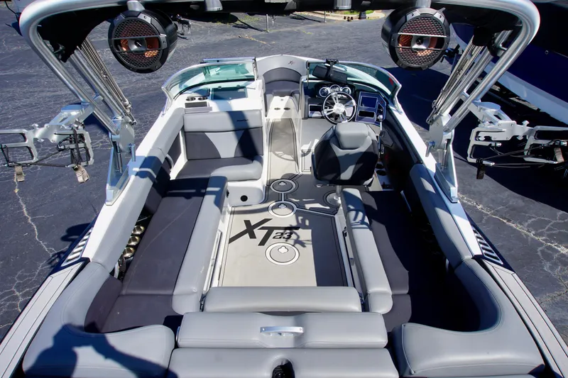 Slide: The Image of 2019 MasterCraft XT23 boat interior with seating and advanced audio system. - 6