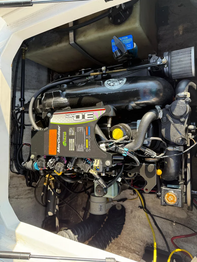 Slide: The Image of Engine compartment of a 2015 Chaparral 18 H2O Sport boat, featuring a MerCruiser 3.0 MPI. - 11