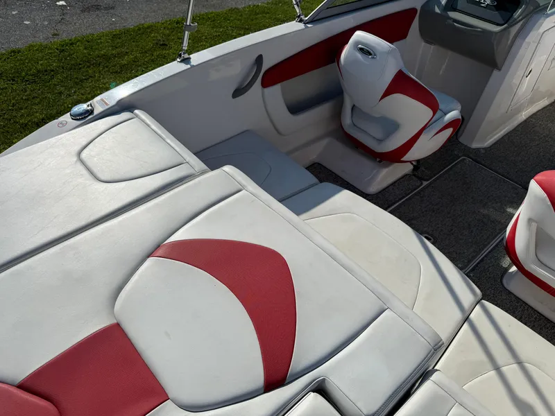 Slide: The Image of 2015 Chaparral 18 H2O Sport boat interior with red and white seating. - 4