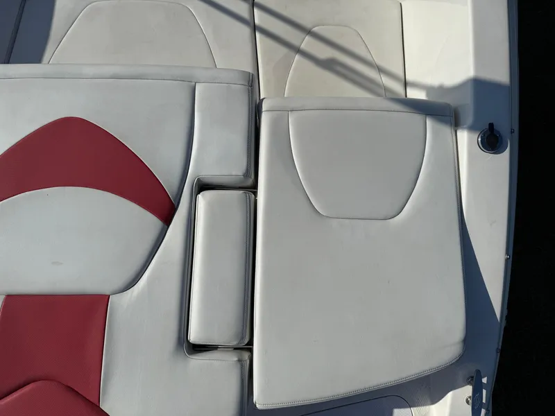 Slide: The Image of 2015 Chaparral 18 H2O Sport boat interior with white and red seating. - 5