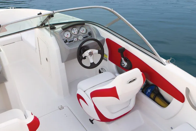 Slide: The Image of Manufacturer Provided Image: 2015 Chaparral 18 H2O Sport boat interior with steering wheel and red accents. - 7