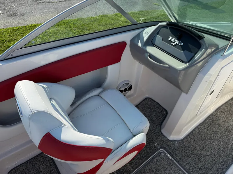 Slide: The Image of 2015 Chaparral 18 H2O Sport boat interior with red and white seating. - 8