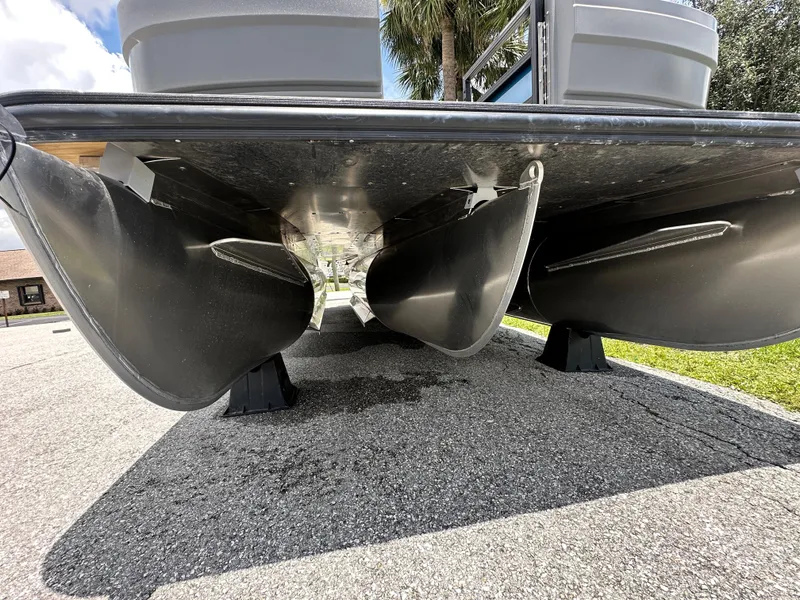 Slide: The Image of Underneath view of 2026 Sylvan A22 LZ Sport pontoon boat on pavement. - 3