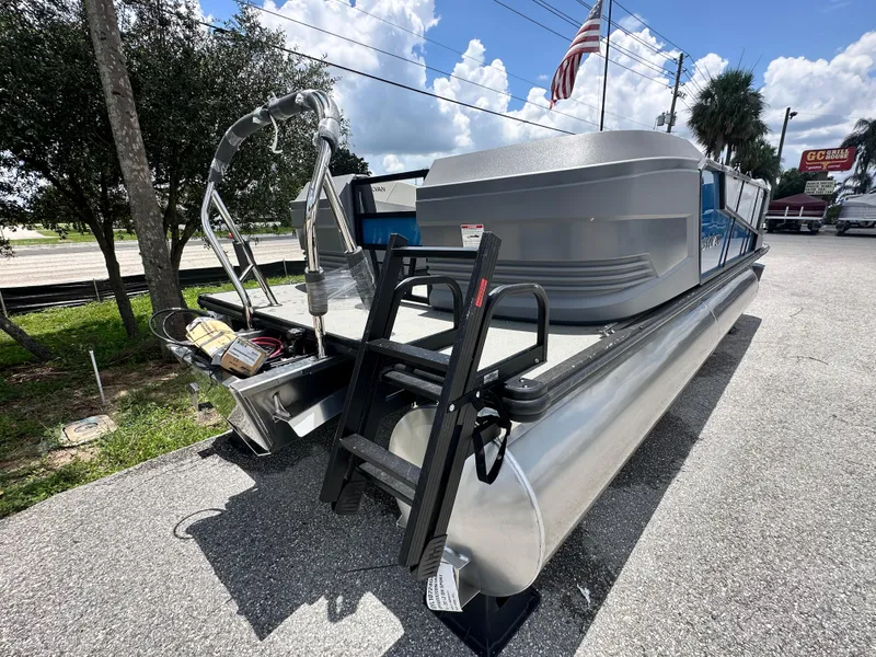 Slide: The Image of 2026 Sylvan A22 LZ Sport pontoon boat displayed outdoors on a sunny day. - 4