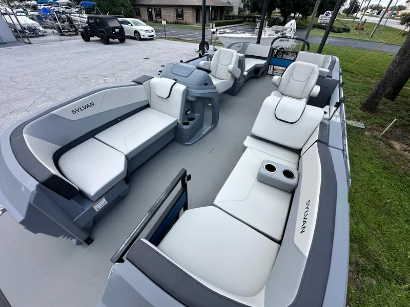 Slide: The Image of 2026 Sylvan A22 LZ Sport boat interior with white seating and cup holders. - 9