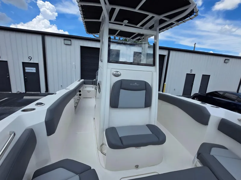 Slide: The Image of 2023 NauticStar 242L Offshore boat interior with seating and console. - 13