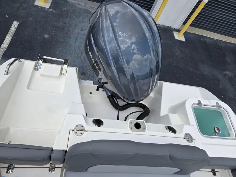 Slide: The Image of 2023 NauticStar 242L Offshore boat with outboard motor and seating area. - 6