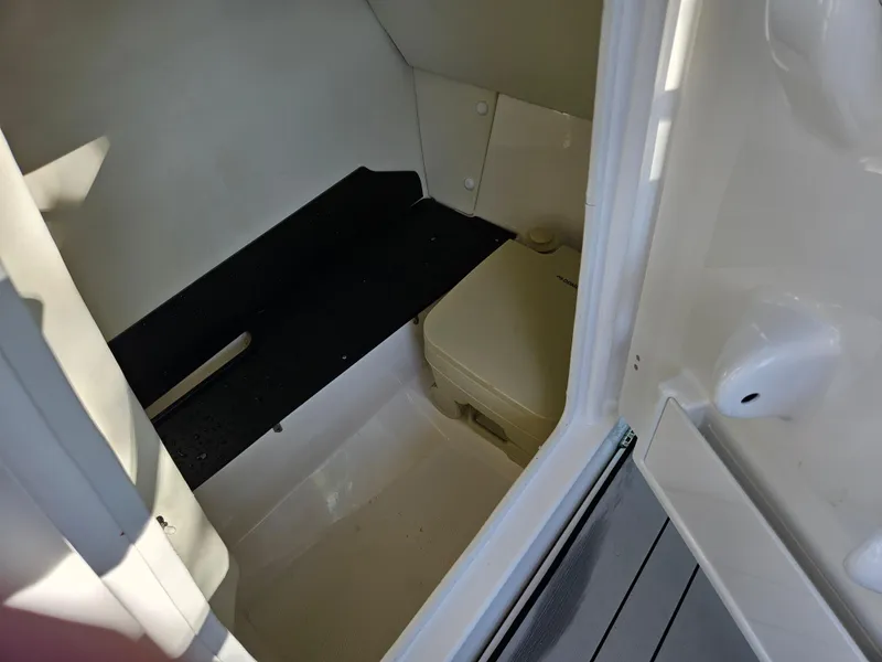 Slide: The Image of Interior cabin of 2020 Yamaha Boats 242X, featuring a compact toilet. - 13