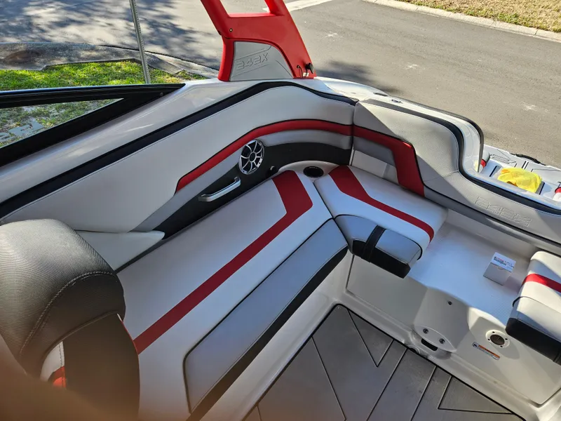 Slide: The Image of Interior seating of a 2020 Yamaha Boats 242X with red and black accents. - 14