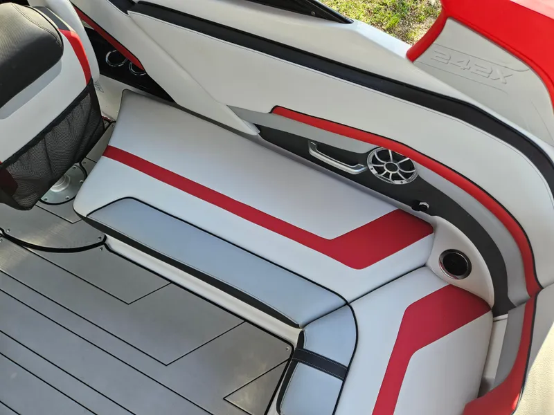 Slide: The Image of Interior seating of a 2020 Yamaha Boats 242X with red and white upholstery. - 19