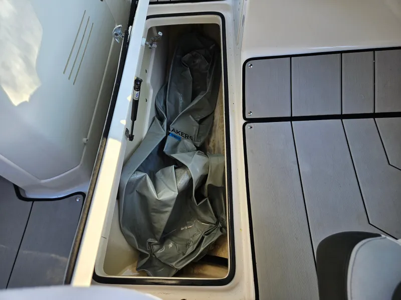 Slide: The Image of Storage compartment of a 2020 Yamaha Boats 242X with cover inside. - 23