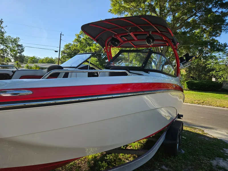 Slide: The Image of 2020 Yamaha Boats 242X in red and white, parked on a trailer. - 27