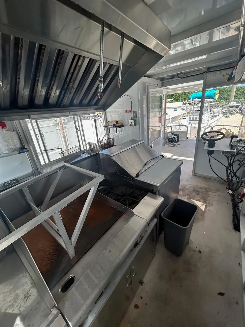 Slide: The Image of Interior of a 2006 3D Craft food truck with kitchen equipment and steering wheel. - 3