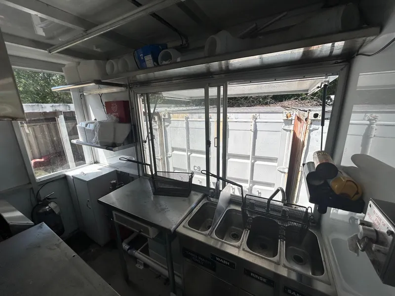 Slide: The Image of Interior of a 2006 3D Craft food truck with sinks and storage shelves. - 4