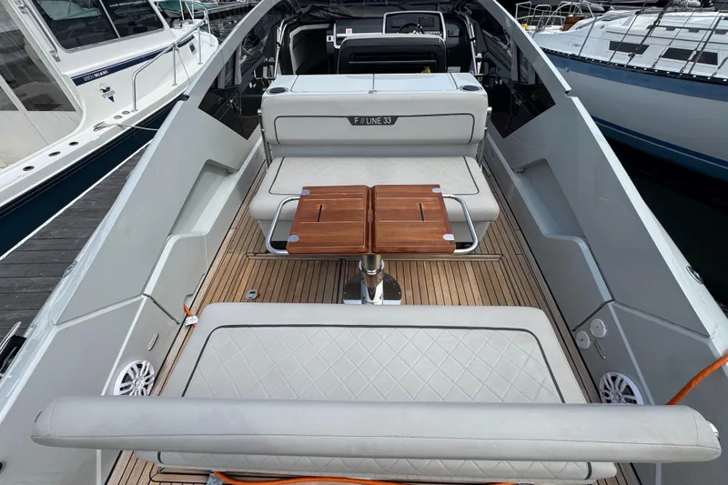Slide: The Image of 2021 Fairline F//Line 33 yacht interior with seating and wooden table. - 12