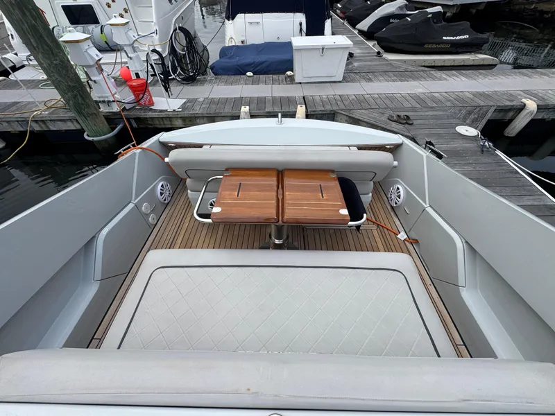 Slide: The Image of 2021 Fairline F//Line 33 yacht interior with wooden table and cushioned seating. - 13
