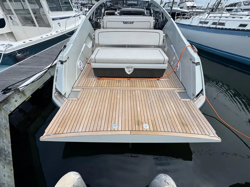 Slide: The Image of 2021 Fairline F//Line 33 yacht with teak deck, docked at marina. - 14