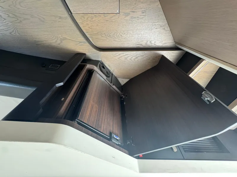 Slide: The Image of Interior view of 2021 Fairline F//Line 33 yacht with open wooden cabinet. - 17