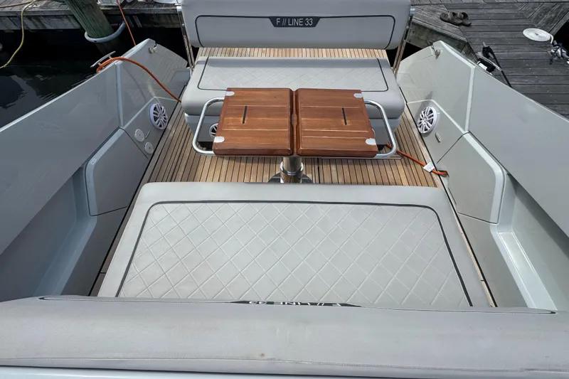 Slide: The Image of 2021 Fairline F//Line 33 boat interior with wooden table and cushioned seating. - 19
