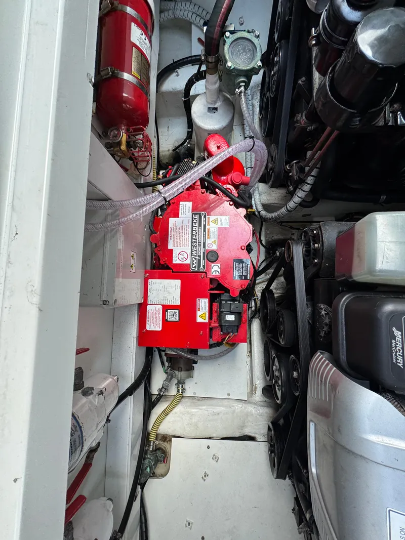 Slide: The Image of Engine compartment of 2021 Fairline F//Line 33 with red battery and fire extinguisher. - 22