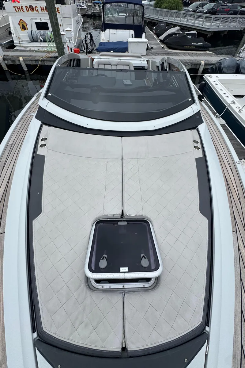 Slide: The Image of 2021 Fairline F//Line 33 yacht with sleek deck design, docked at marina. - 4