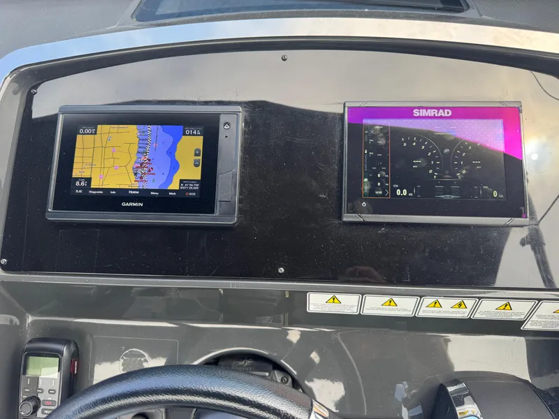 Slide: The Image of Dashboard of 2021 Fairline F//Line 33 with Garmin and Simrad navigation displays. - 6