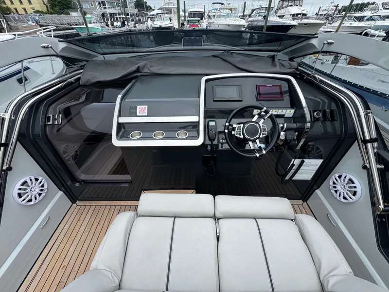 Slide: The Image of 2021 Fairline F//Line 33 yacht cockpit with modern steering and navigation controls. - 9